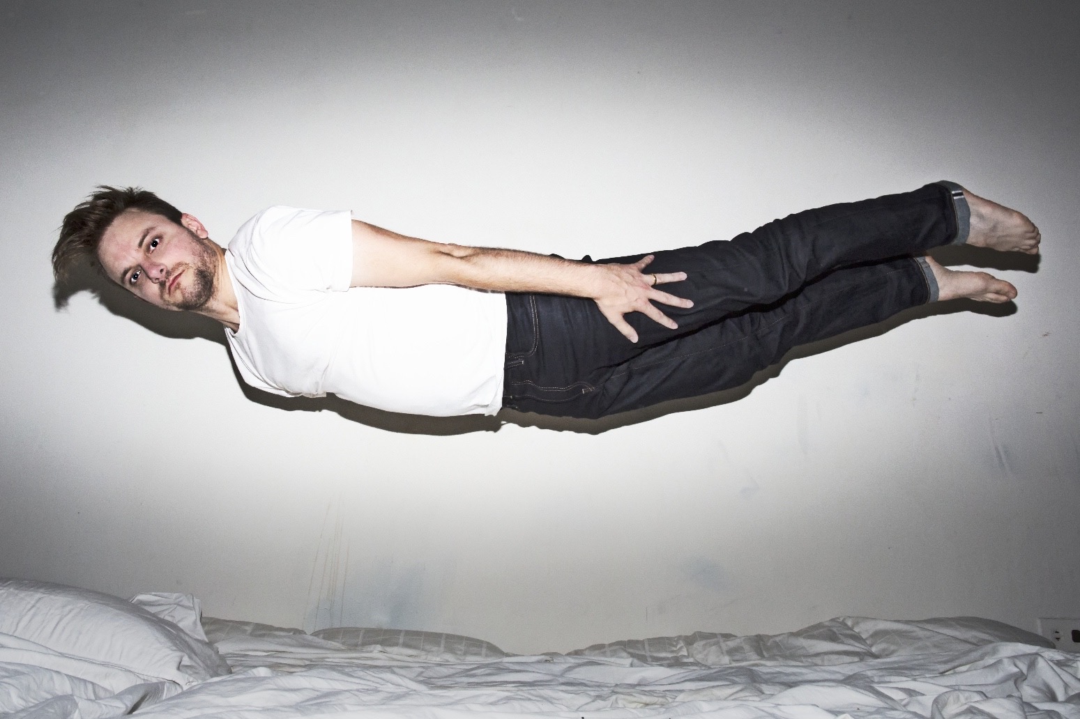 Sydney Skybetter hovering over a bed